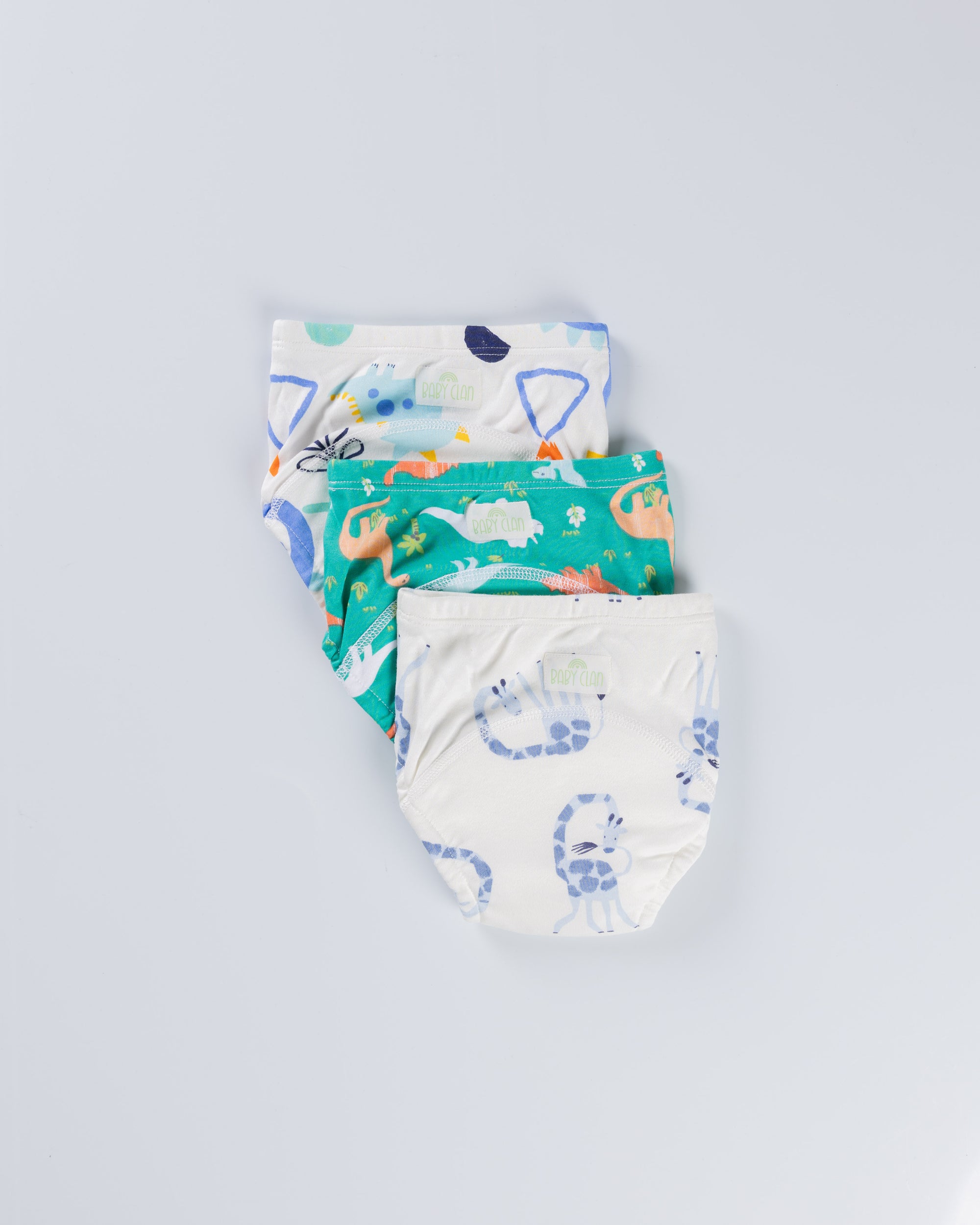 Three children's underwear with colorful patterns on a light gray background